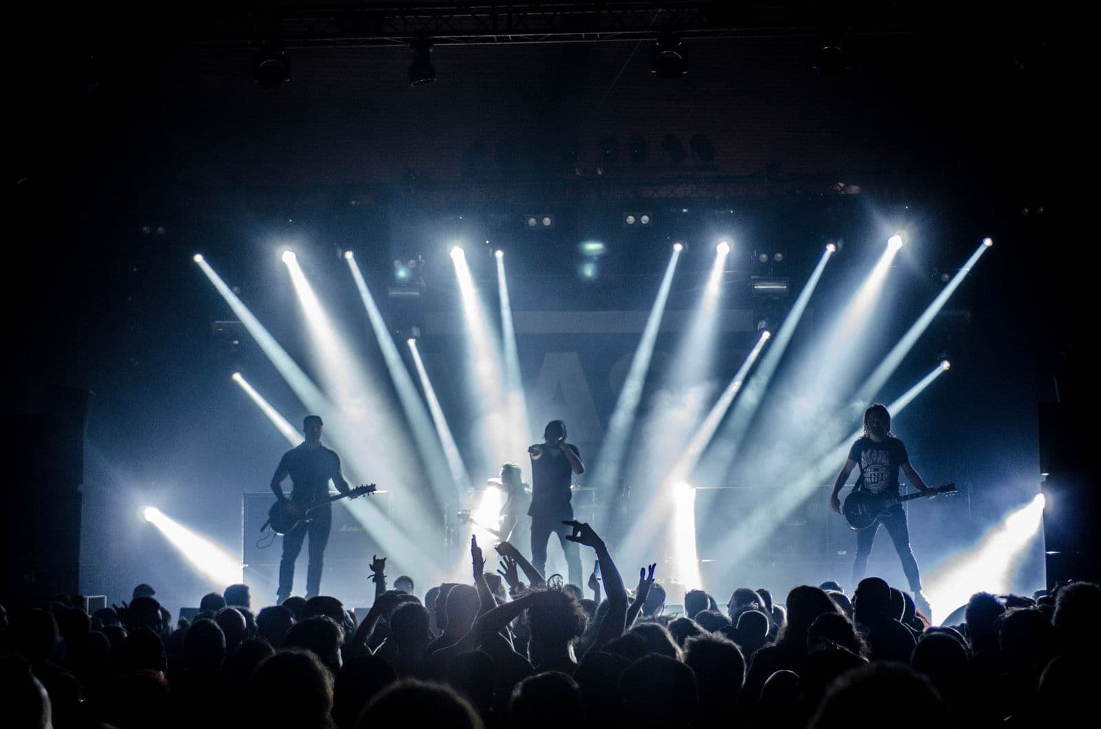 A performer on stage under warm coloured lights during a live show.