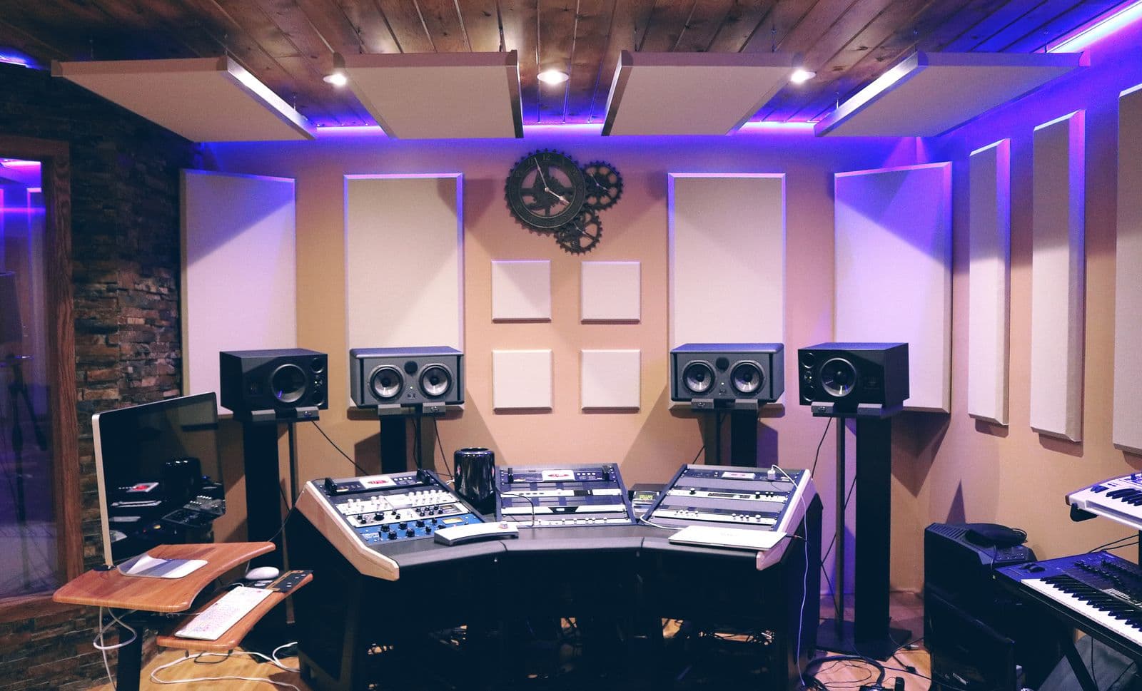 A mixing console glowing under low studio light, faders and knobs in focus.